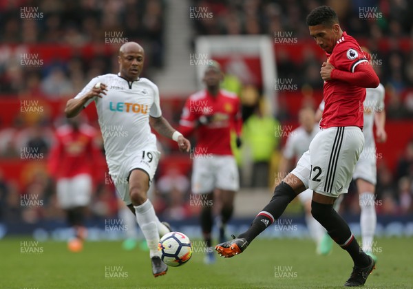 310318 - Manchester United v Swansea City - Premier League -  Andre Ayew of Swansea and Chris Smalling of Manchester United