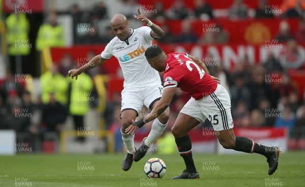 310318 - Manchester United v Swansea City - Premier League -  Andre Ayew of Swansea and Antonio Valencia of Manchester United