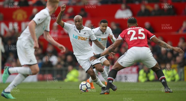 310318 - Manchester United v Swansea City - Premier League -  Andre Ayew of Swansea and Antonio Valencia of Manchester United