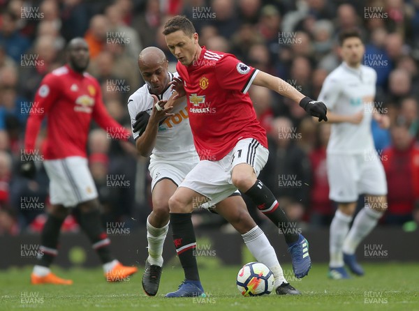 310318 - Manchester United v Swansea City - Premier League -  Andre Ayew of Swansea tackles Nemanja Matic of Manchester United