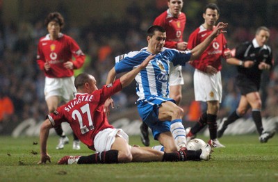 260206 - Manchester United v Wigan Athletic - Carling Cup Final - Wigan's Paul Scharner is tackled by Michael Silvestre 