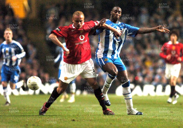 260206 - Manchester United v Wigan Athletic - Carling Cup Final - Man Utd's Wes Brown tries to control the ball under pressure from Jason Roberts