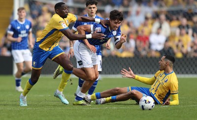 020526 - Mansfield Town v Cardiff City - Sky Bet League 1 - Rubin Colwill of Cardiff is challenged by Deji Oshilaja of Mansfield and Lucas Atkins of Mansfield