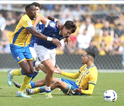 020526 - Mansfield Town v Cardiff City - Sky Bet League 1 - Rubin Colwill of Cardiff is caught by Lucas Atkins of Mansfield