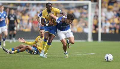 020526 - Mansfield Town v Cardiff City - Sky Bet League 1 - Rubin Colwill of Cardiff is caught by Lucas Atkins of Mansfield