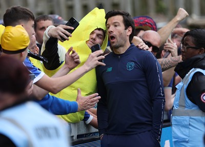 020526 - Mansfield Town v Cardiff City - Sky Bet League 1 - Manager Brian Barry-Murphy of Cardiff salutes the travelling fans and is hugged by some in fancy dress all wanting selfies