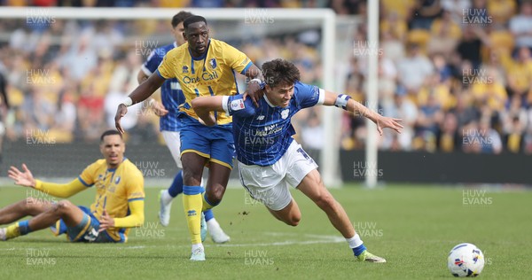020526 - Mansfield Town v Cardiff City - Sky Bet League 1 - Rubin Colwill of Cardiff is caught by Lucas Atkins of Mansfield