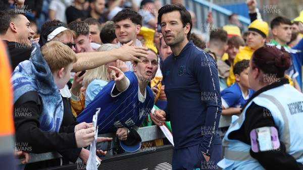 020526 - Mansfield Town v Cardiff City - Sky Bet League 1 - Manager Brian Barry-Murphy of Cardiff salutes the travelling fans and is hugged by some in fancy dress all wanting selfies