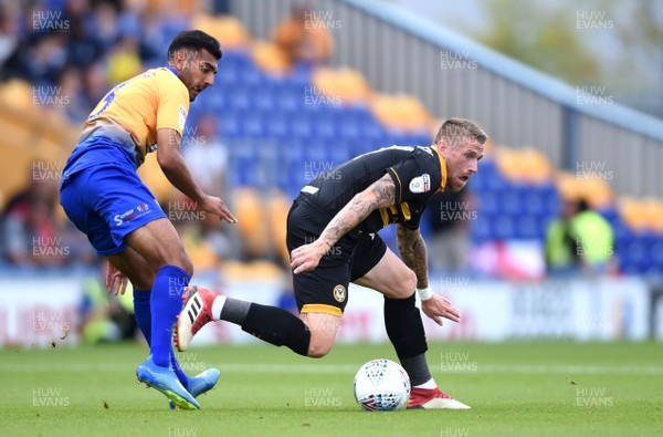 040818 - Mansfield Town v Newport County - League 2 - Scot Bennett of Newport County is tackled by Malvind Benning of Mansfield Town