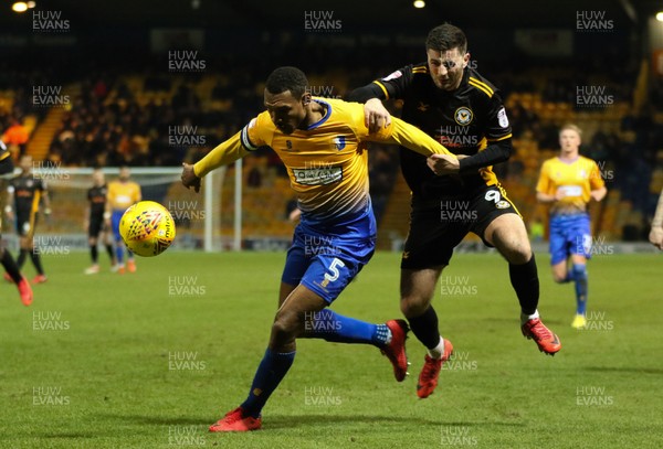 130218 - Mansfield Town v Newport County, Sky Bet League 2 - Krystian Pearce of Mansfield Town and Padraig Amond of Newport County compete for the ball