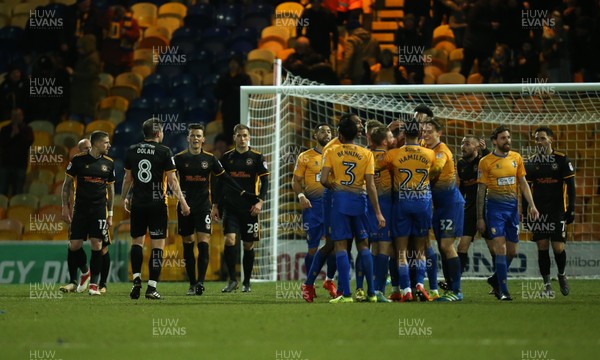 130218 - Mansfield Town v Newport County, Sky Bet League 2 - Newport County players question each other as Mansfield players celebrate the fourth goal