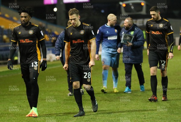 130218 - Mansfield Town v Newport County, Sky Bet League 2 - Newport County players Marlon Jackson, Mickey Demetriou and Ben Tozer leave the pitch at the end of the match