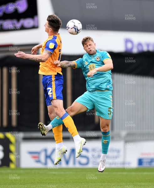 140821 - Mansfield Town v Newport County - EFL SkyBet League 2 - Oliver Hawkins of Mansfield Town and James Clarke of Newport County compete in the air