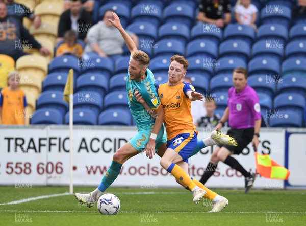 140821 - Mansfield Town v Newport County - EFL SkyBet League 2 - Cameron Norman of Newport County is tackled by Stephen Quinn of Mansfield Town