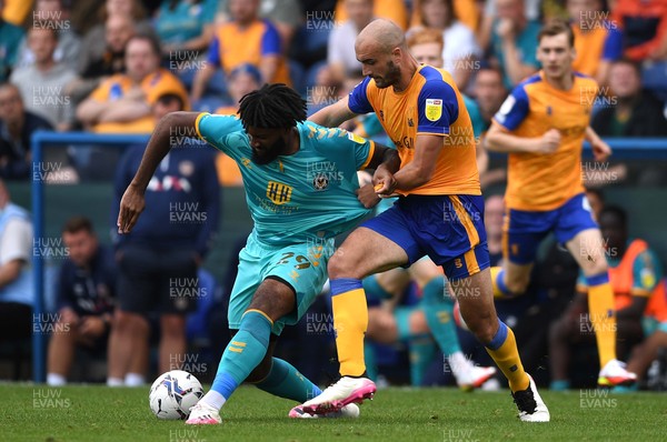 140821 - Mansfield Town v Newport County - EFL SkyBet League 2 - Jordan Greenidge of Newport County is tackled by Farrend Rawson of Mansfield Town