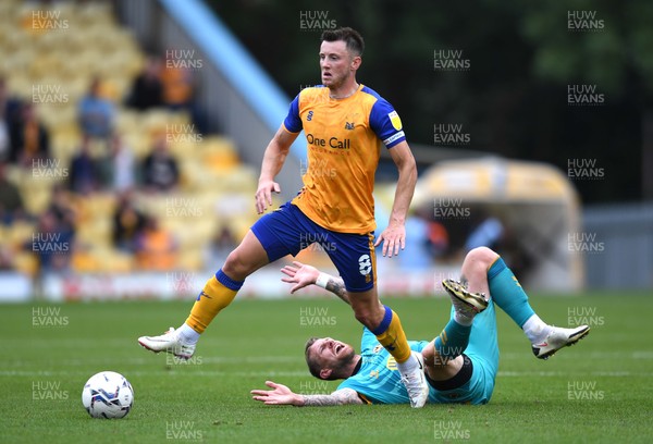 140821 - Mansfield Town v Newport County - EFL SkyBet League 2 - Ollie Clarke of Mansfield Town is tackled by Scot Bennett of Newport County