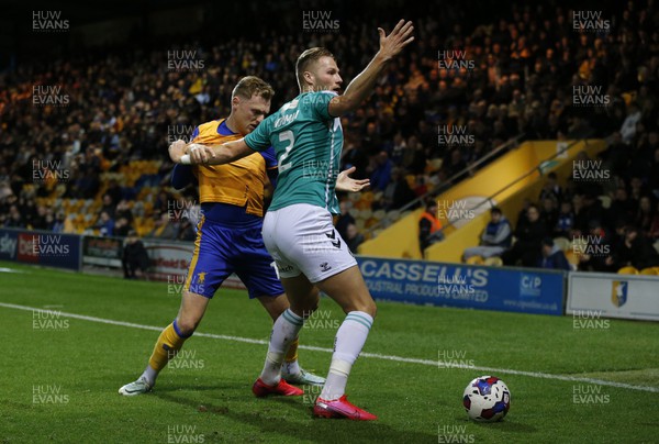 251022 - Mansfield Town v Newport County - Sky Bet League 2 - Cameron Norman of Newport County tries to escape from George Maris of Mansfield Town and appeals to linesman