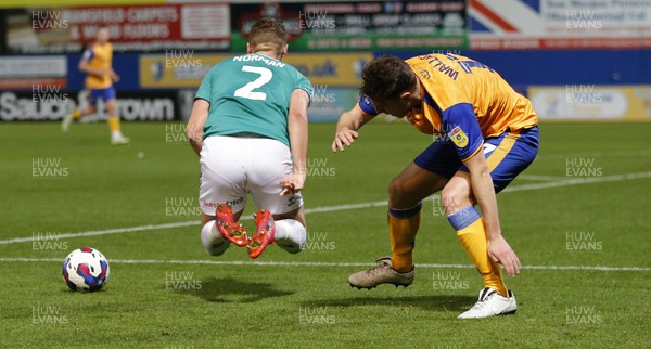 251022 - Mansfield Town v Newport County - Sky Bet League 2 - Cameron Norman of Newport County is tripped by Kieran Wallace of Mansfield Town
