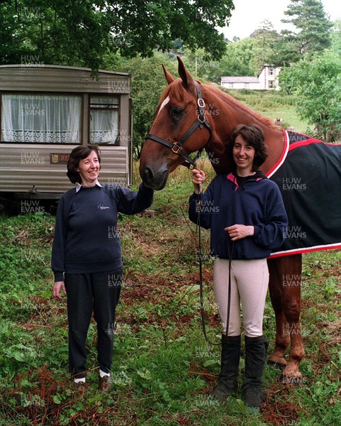 280793 - Picture shows Marion Bevan and daughter Lynne with horse Sid and their caravan home with their old house on the mountain behind