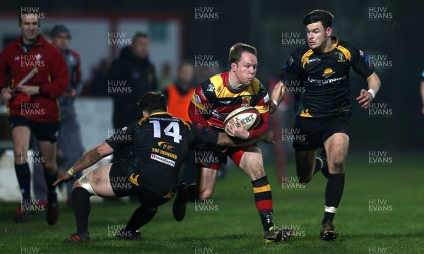 150317 - Merthyr RFC v Carmarthen Quins - Foster's Cup Semi Final - Christopher Canfield of Carmarthen is tackled by Dan Parry of Merthyr