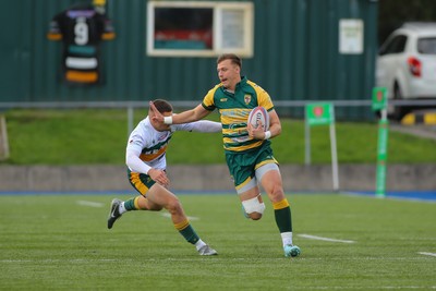 101026 - Merthyr v Beddau - Admiral WRU Premiership - Ioan Griffith of Beddau fends off Jack Kathren of Merthyr