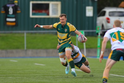 101026 - Merthyr v Beddau - Admiral WRU Premiership - Ioan Griffith of Beddau fends off the tackle of Jack Kathren of Merthyr