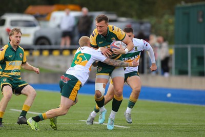 101026 - Merthyr v Beddau - Admiral WRU Premiership - Ioan Griffith of Beddau is tackled by Cole Swannack of Merthyr