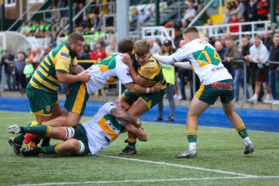101026 - Merthyr v Beddau - Admiral WRU Premiership - Ewan Roberts of Beddau is tackled short of the line by Evan Wood(L) Daniel Phillips and Jack Kathren of Merthyr