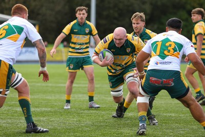 101026 - Merthyr v Beddau - Admiral WRU Premiership - Lloyd Evans of Beddau takes on Daniel Phillips(L) and Amose Nova of Merthyr