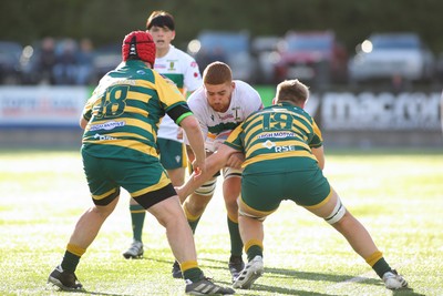 101026 - Merthyr v Beddau - Admiral WRU Premiership - Daniel Phillips of Merthyr is tackled by Lucca Alexander White of Beddau