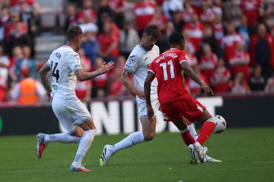 090825 - Middlesbrough v Swansea City - Sky Bet Championship - Swansea City's Cameron Burgess and Josh Tymon put pressure on Middlesbrough's Morgan Whittaker