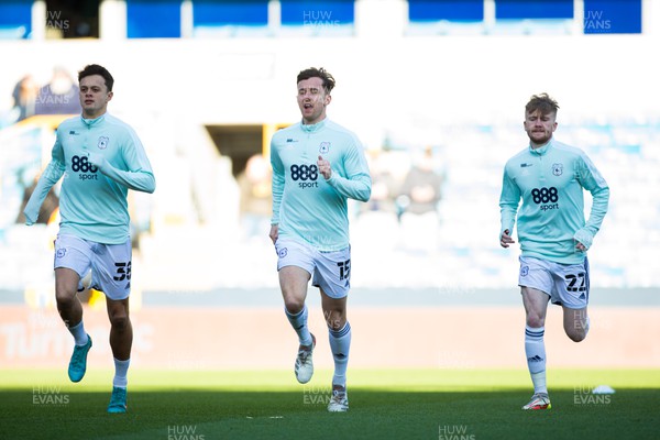120222 - Millwall v Cardiff City - Sky Bet Championship - Aden Flint, Perry Ng and Tommy Doyle of Cardiff City warms up