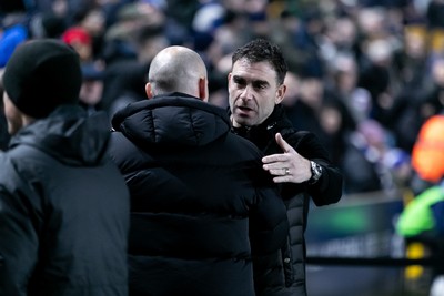 210125 - Millwall v Cardiff City - Sky Bet Championship - Ömer Riza manager of Cardiff City greets Alex Neil manager of Millwall