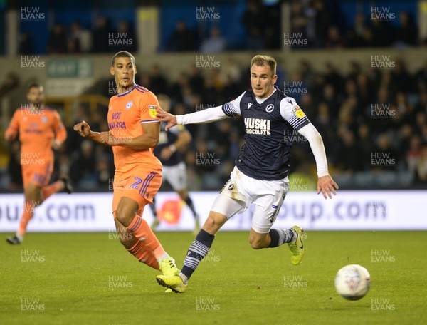 221019 - Millwall v Cardiff City - Sky Bet Championship -  Cardiff's Lee Peltier beats Millwall's Jed Wallace to the ball