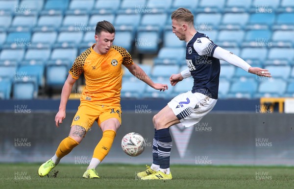 040120 - Millwall v Newport County - FA Cup Round 3 - George Nurse of Newport County is tackled by Jason McCarthy of Millwall