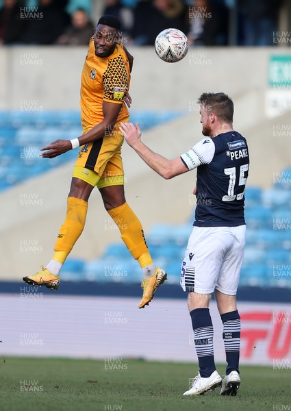 040120 - Millwall v Newport County - FA Cup Round 3 - Jamille Matt of Newport County goes up for the ball alongside Alex Pearce of Millwall