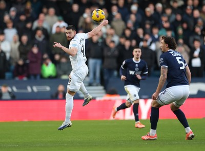 040126 - Millwall v Swansea City, EFL Sky Bet Championship - Zan Vipotnik of Swansea City heads the ball forward