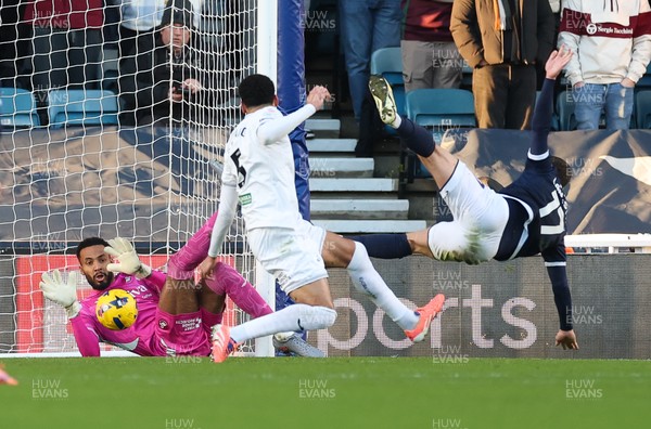040126 - Millwall v Swansea City, EFL Sky Bet Championship - Swansea City goalkeeper Lawrence Vigouroux saves from Macaulay Langstaff of Millwall