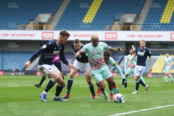 100421 - Millwall v Swansea City - Sky Bet Championship - Andre Ayew of Swansea City holds off the challenge from Jake Cooper of Millwall