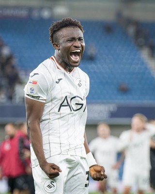 131026 - Millwall v Swansea City - Sky Bet Championship -  Joseph Opoku of Swansea City celebrates with fans