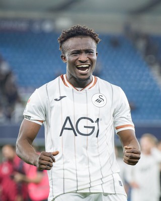 131026 - Millwall v Swansea City - Sky Bet Championship -  Joseph Opoku of Swansea City celebrates with fans