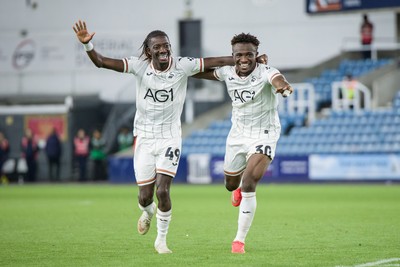 131026 - Millwall v Swansea City - Sky Bet Championship -   Moussa Kounfolo Yeo of Swansea City and Joseph Opoku of Swansea City celebrate with fans