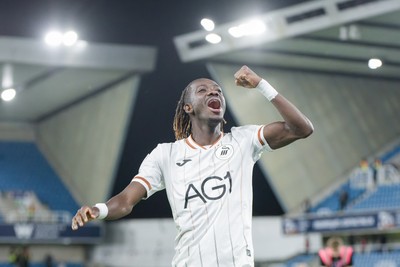 131026 - Millwall v Swansea City - Sky Bet Championship -   Moussa Kounfolo Yeo of Swansea City celebrates with fans
