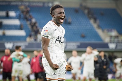 131026 - Millwall v Swansea City - Sky Bet Championship -  Joseph Opoku of Swansea City celebrates with fans