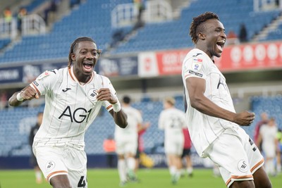 131026 - Millwall v Swansea City - Sky Bet Championship -  Moussa Kounfolo Yeo of Swansea City and Joseph Opoku of Swansea City celebrate with fans