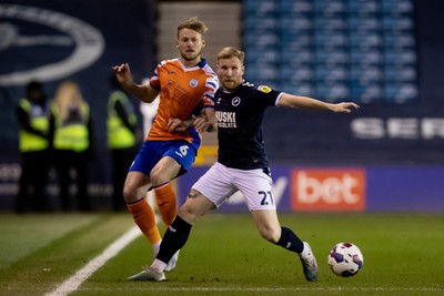 140323 - Millwall v Swansea City - Sky Bet Championship - Harry Darling of Swansea City and Andreas Voglsammer of Millwall battle for the ball