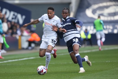 260425 - Millwall v Swansea City - Sky Bet Championship - Ronald of Swansea tussles with Zak Sturge of Millwall
