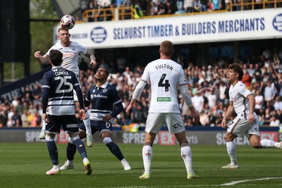260425 - Millwall v Swansea City - Sky Bet Championship - Lewis O'Brien of Swansea heads the ball 