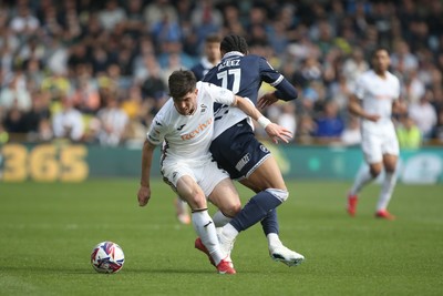 260425 - Millwall v Swansea City - Sky Bet Championship - Josh Key of Swansea tussles with Femi Azeez of Millwall