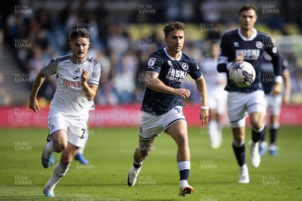 300923 - Millwall v Swansea City - Sky Bet Championship - Joe Bryan of Millwall in action against Liam Cullen of Swansea City